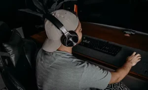 a-man-wearing-headphone in front of computer
