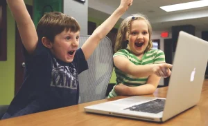 A child boy and girl enjoy with your laptop screen