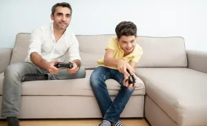 Father and son playing the game at the home